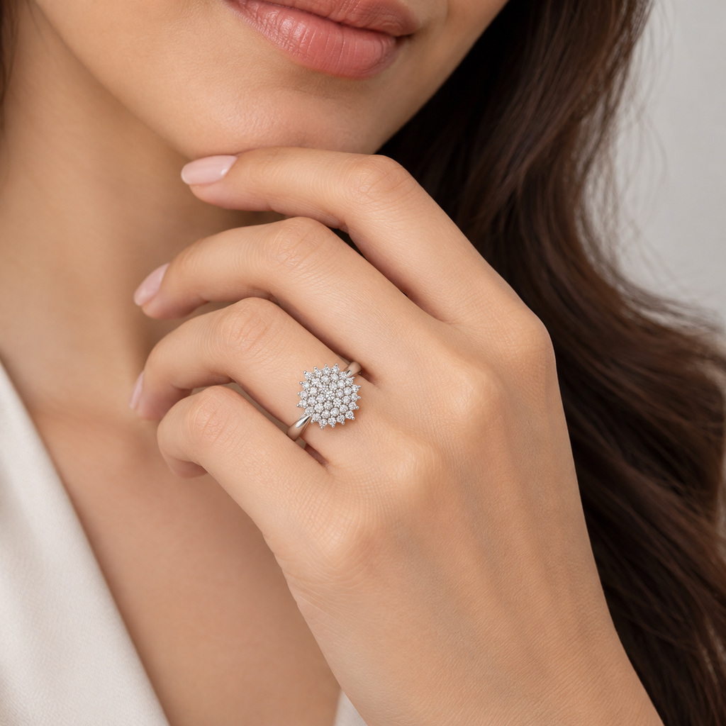 Close up of a woman wearing a round diamond cluster engagement ring