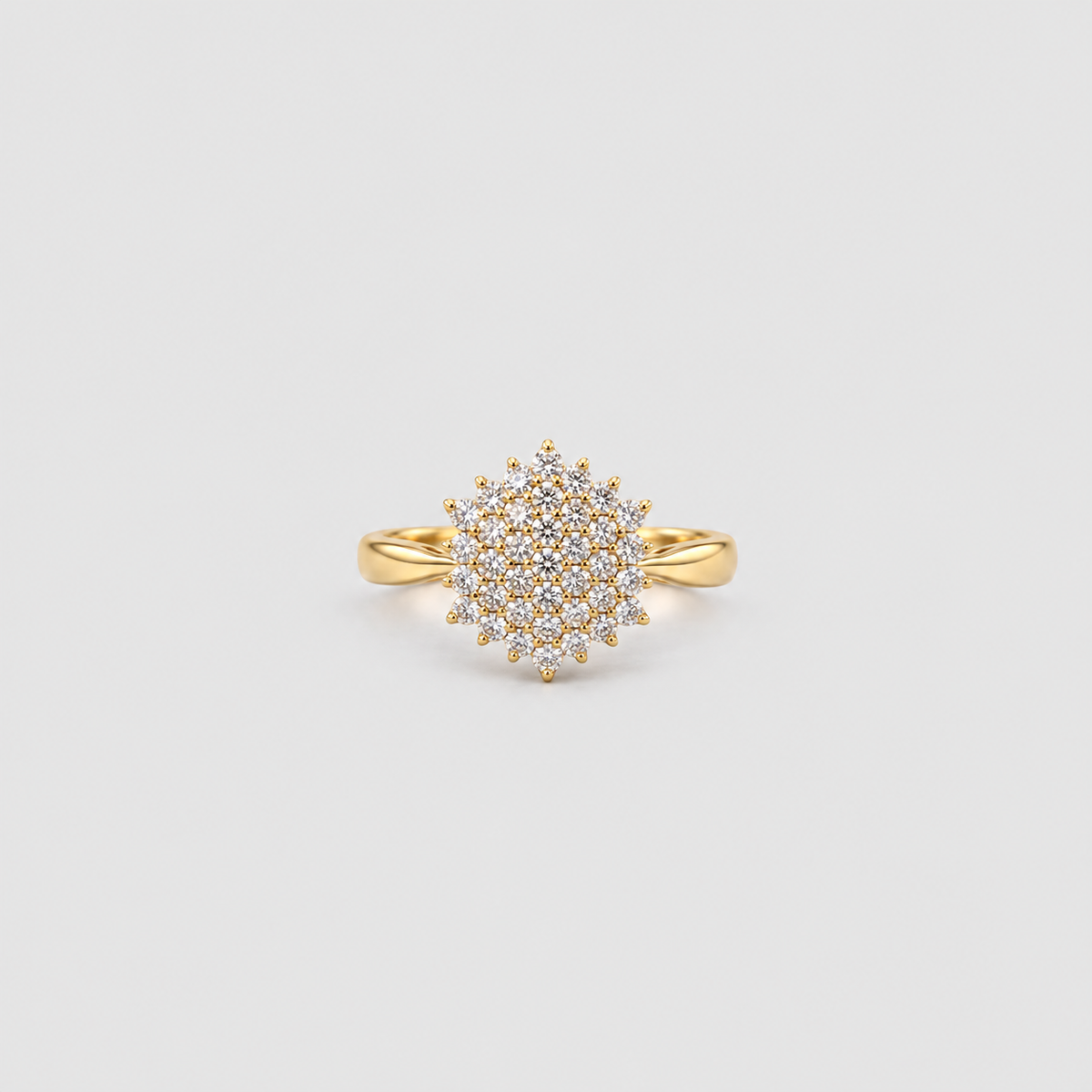 Women's yellow gold diamond cluster statement ring on a grey background.