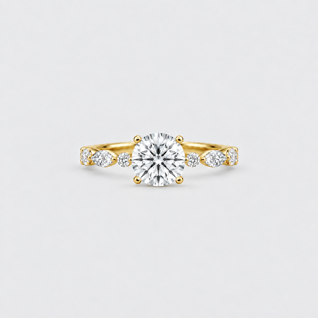 A yellow gold solitaire engagement ring with a round brilliant-cut center stone and smaller marquise-cut side stones, set against a light gray background.