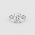 A radiant cut diamond engagement ring with a silver-colored band accented by small side diamonds, centered on a light gray background.