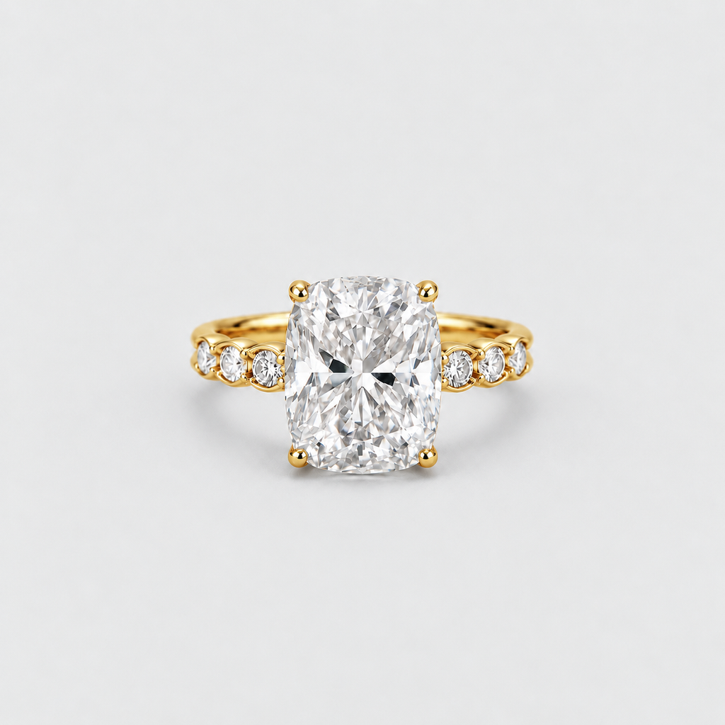 A yellow gold engagement ring featuring a large cushion-cut diamond center stone and smaller diamonds set along the shoulders, shown on a light gray background.