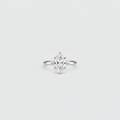 A silver engagement ring featuring a marquise-cut diamond center stone in a prong setting, shown against a clean, light gray background.