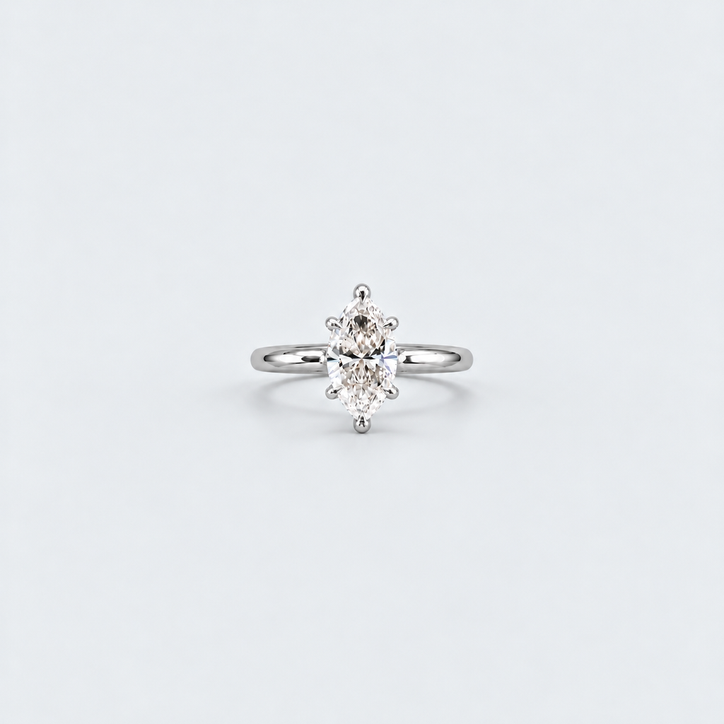 A silver solitaire ring featuring a marquise-cut diamond, set against a clean, light gray background.