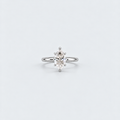 A silver solitaire ring featuring a marquise-cut diamond, set against a clean, light gray background.