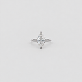 A single marquise-cut diamond engagement ring in a silver-toned setting, centered on a light gray background.