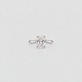A single solitaire engagement ring featuring a round brilliant-cut diamond set in a polished silver-colored band, centered on a light gray background.