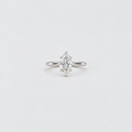 A silver ring featuring a marquise-cut diamond cluster setting on a plain light gray background.