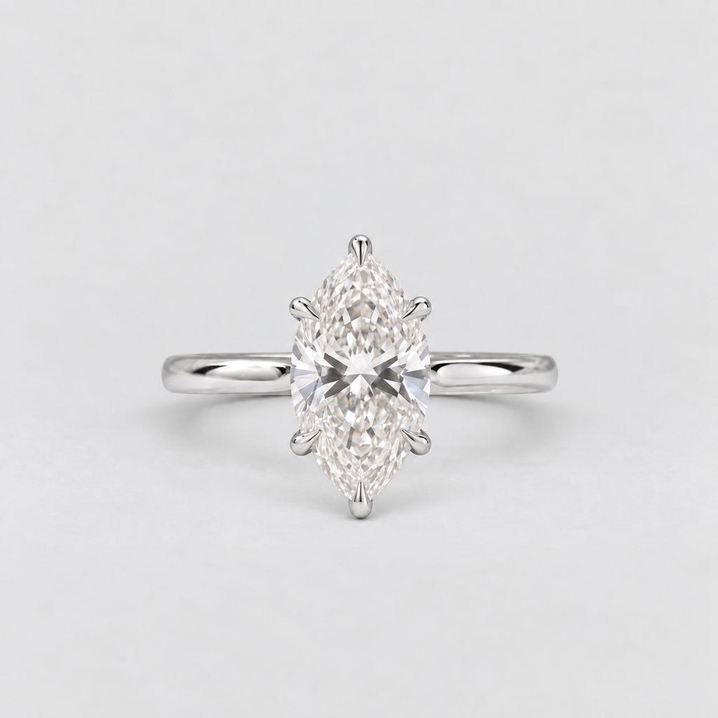 A silver engagement ring featuring a marquise-cut diamond center stone in a six-prong setting, shown on a light gray background.