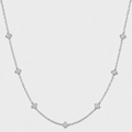 A delicate silver chain necklace featuring small diamond-shaped diamond accents spaced along the chain, photographed against a light gray background.