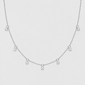 A delicate silver-toned chain necklace featuring five small, clear round-cut gemstones spaced along the chain, displayed against a solid light gray background.