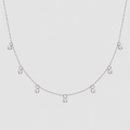 A delicate silver-tone chain necklace featuring five small clear crystal charms spaced along the front, displayed against a solid light gray background.