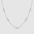 A delicate silver chain necklace featuring a series of small, evenly spaced round-cut clear gemstones in bezel settings, displayed against a light gray background.