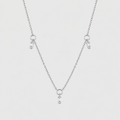 A delicate silver ball chain necklace featuring three small dangling charms, each with a clear teardrop-shaped crystal, set against a solid light gray background.