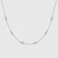 A delicate silver chain necklace featuring five small oval bezel-set clear stones, displayed against a clean, light gray background.