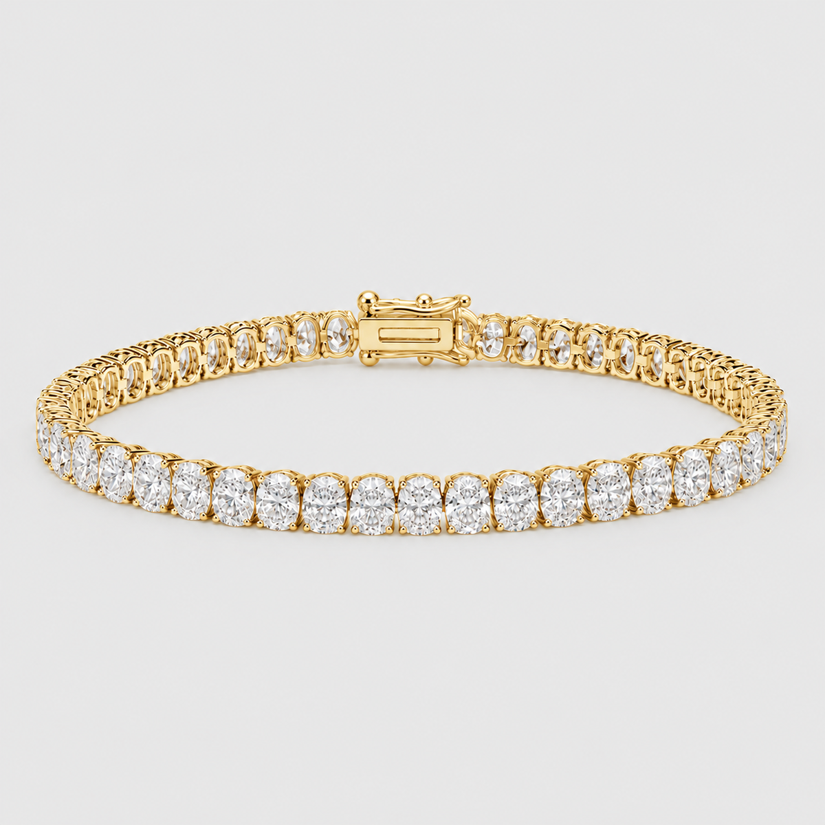 A yellow gold tennis bracelet featuring round-cut clear gemstones set in a classic link design, shown against a light gray background.