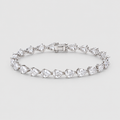 A silver tennis bracelet featuring a row of pear-cut clear gemstones in a prong setting, displayed on a light gray background.