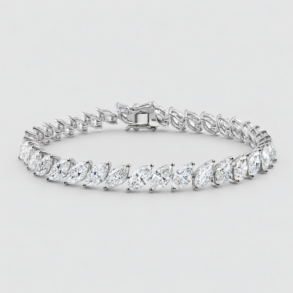 A silver tennis bracelet featuring marquise-cut clear gemstones in a continuous row, displayed on a clean light gray background.
