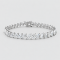 A silver tennis bracelet featuring marquise-cut clear gemstones in a continuous row, displayed on a clean light gray background.