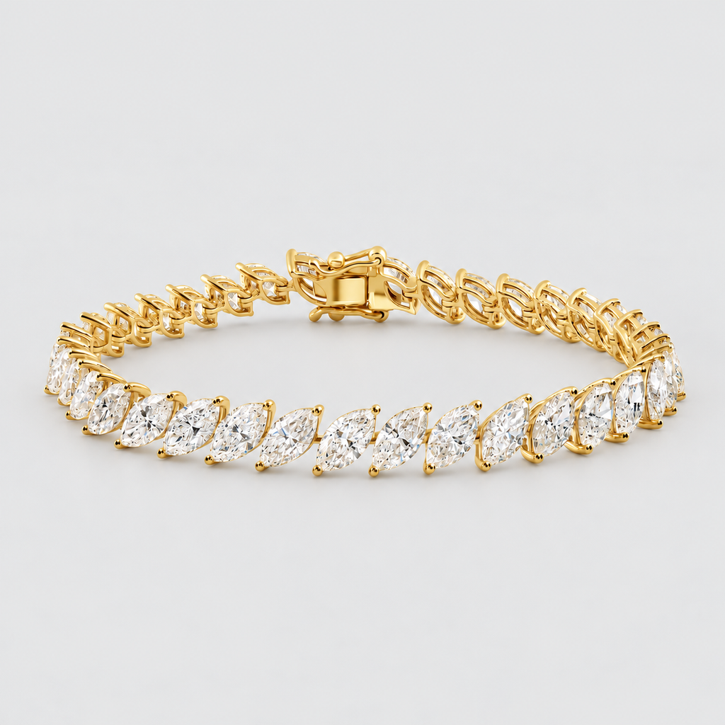 A yellow gold tennis bracelet featuring marquise-cut clear gemstones in a classic solitaire setting, displayed on a clean light gray background.